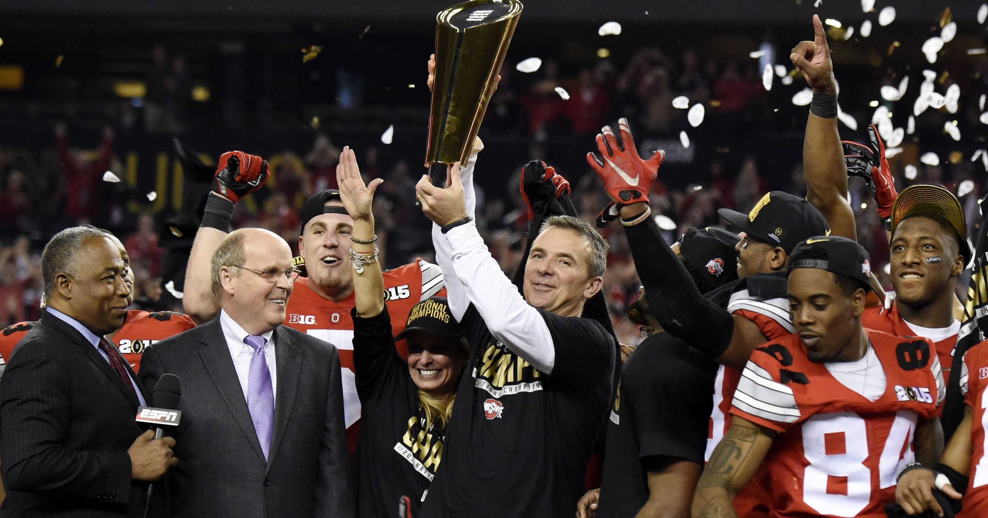 Urban Meyer holds the CFP trophy with Ohio State