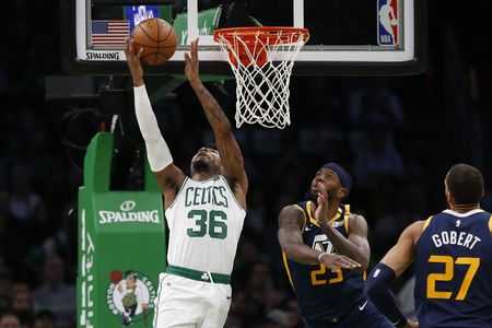 Marcus Smart attempts a layup against smothering Jazz defense. The Conley 
and Gobert duo helped to smother the C's Friday night.
