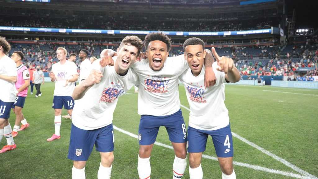 USMNT players Christian Pulisic, Weston McKennie, and Tyler Adams celebrate the Nations League victory.