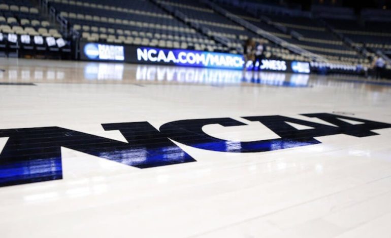 A basketball floor with the NCAA logo on it. "pictured here"