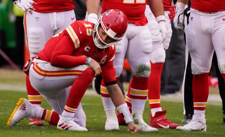 Kansas City Chiefs quarterback Patrick Mahomes taking a knee during a game. "pictured here"