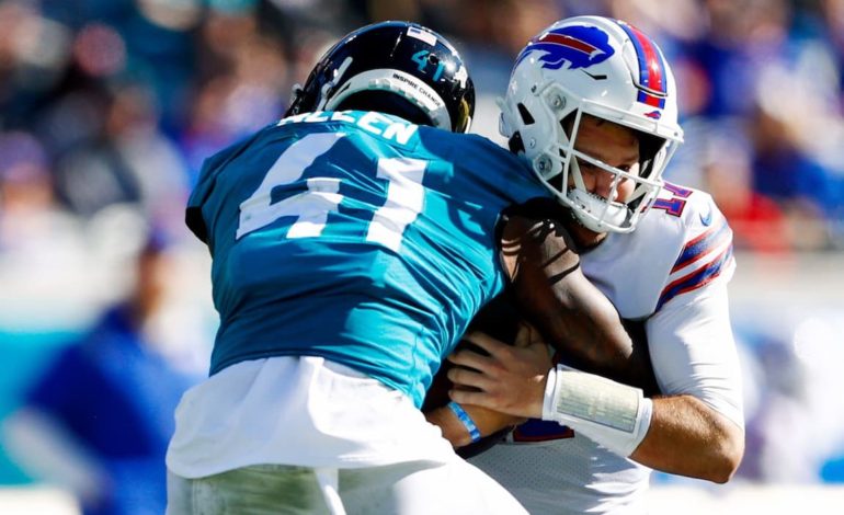 Jacksonville Jaguars linebacker Josh Allen tackling the Buffalo Bills quarterback Josh Allen during a game. "pictured here"