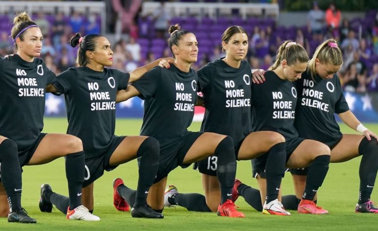 A group of players from the NWSL kneeling in solidarity protesting the abuse they received from those in the league. "pictured here"