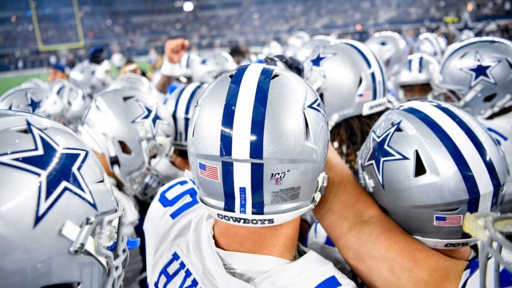Dallas Cowboys in a team huddle before a game last year. "pictured here"