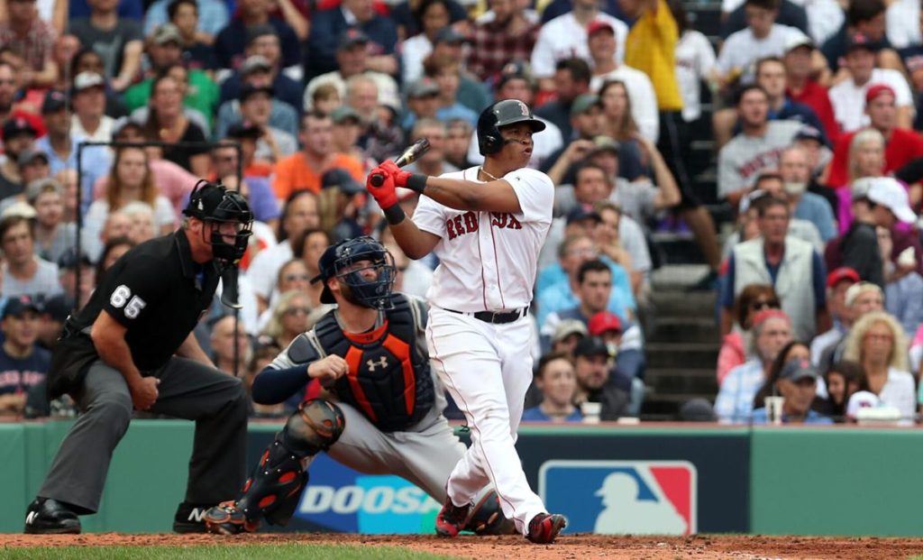 Boston Red Sox Rafael Devers hitting at Fenway Park in Boston's home white jersey's with red lettering. Will an elite bat outweigh subpar defense in Rafael Devers' contract extension negotiations? 