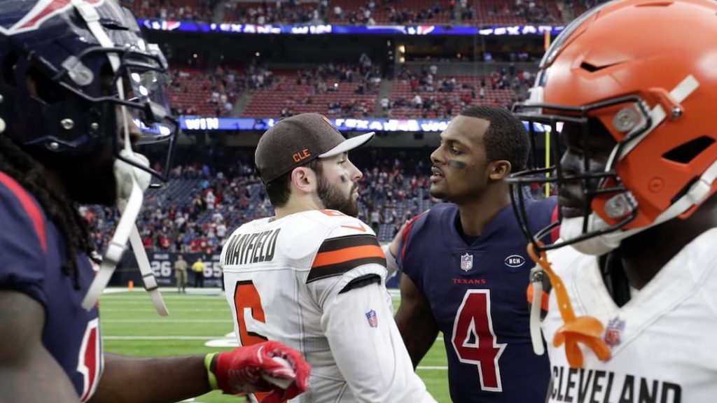 Cleveland Browns quarterback Baker Mayfield shaking hands with recently acquired Deshaun Watson after a game. "pictured here"