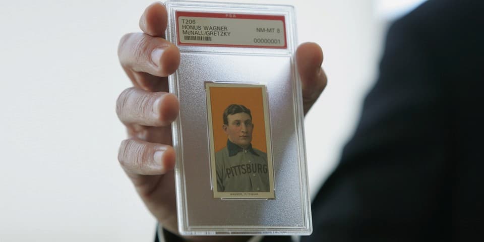 The Honus Wagner's T206 trading card in a protective case being held at auction. "pictured here" 