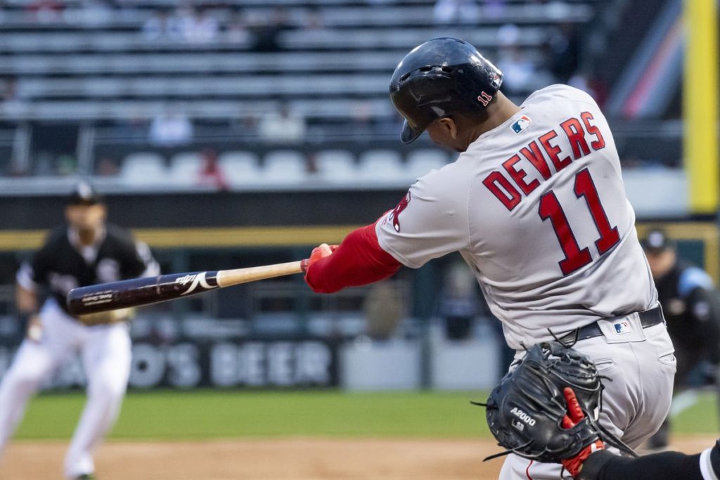 Boston Red Sox Rafael Devers hitting in Chicago in Boston's road grey jersey with red lettering. A Rafael Devers contract extension might not be so simple.  