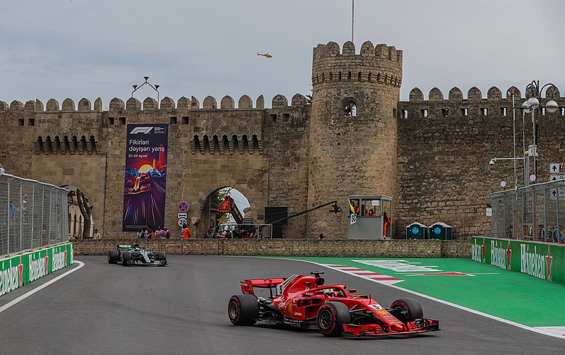 Sebastien Vettel in the Ferrari SF71H ahead of Lewis Hamilton in the Mercedes W09 through the Old City. (Source: WikiCommons)