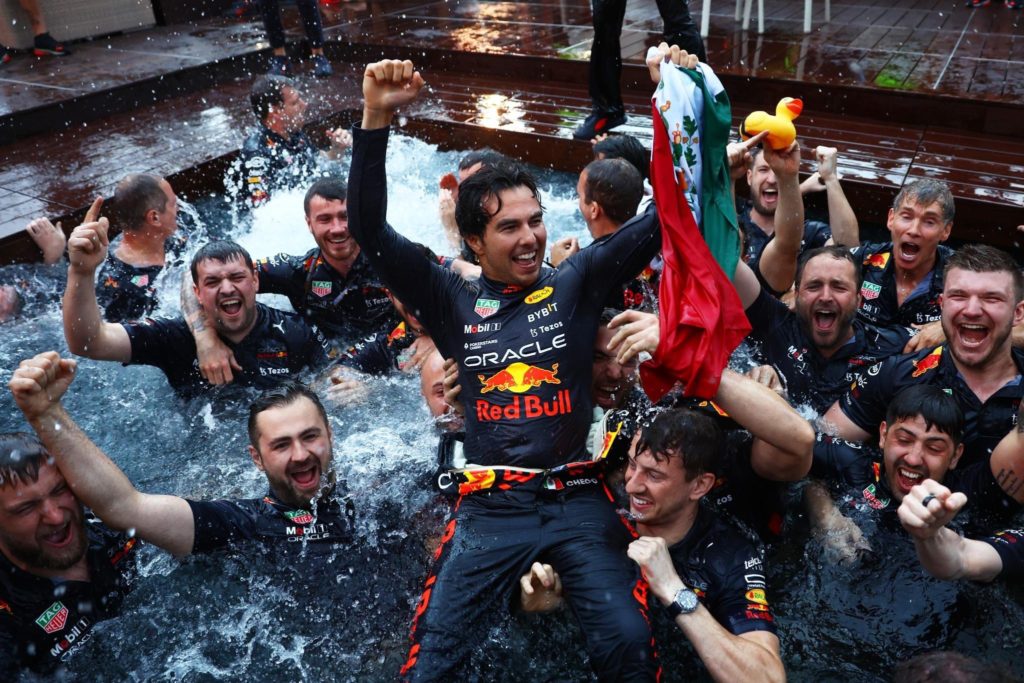 Sergio Perez (center) and team Red Bull taking a customary dip in the Monaco swimming pool after his win. (Source Twitter:@MexicanF1Power)