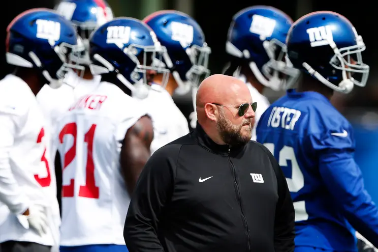 New York Giants Head Coach Brian Daboll (in black) with his players
