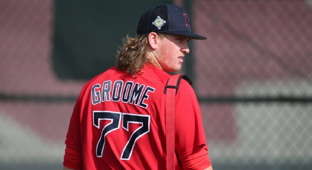 The Red Sox sent Jay Groome to San Diego in their fourth of four deals at the trade deadline. Groome has fallen off considerably. Pictured: Jay Groome during spring training in the Red Sox' Red alternate jersey with blue lettering and white trim. He is wearing Boston's dark blue/black mesh spring training cap. 