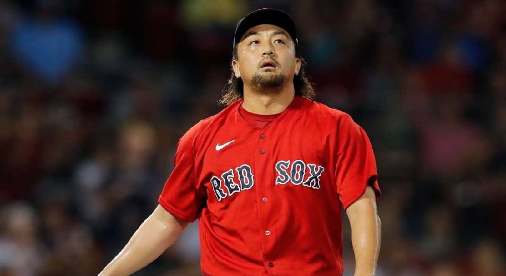 HIrokazu Sawamura stares blankly after an appearance out of the Red Sox bullpen. He is wearing Boston's Red alternate jersey with blue lettering and white trim. 