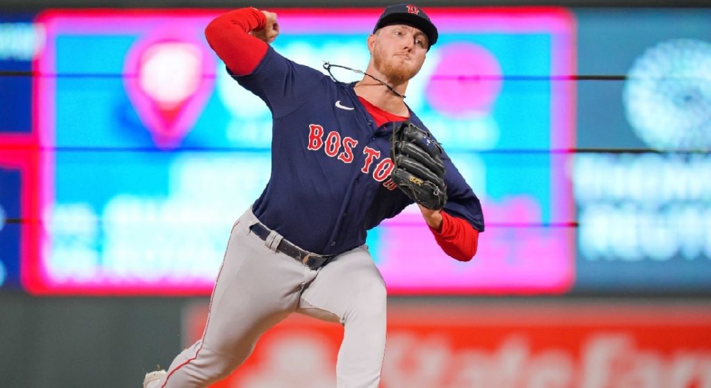 Zack Kelly making one of his first two MLB appearances out of the Red Sox bullpen vs. the Twins. He is wearing Boston's blue alternate jersey with red lettering and white trim with grey pants. 