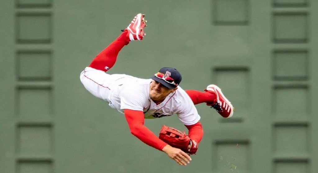 Giving Enrique Hernandez - pictured here airborne as he throws the ball to the infield - a contract extension assures the Red Sox at least one stellar outfield defender in 2023. 