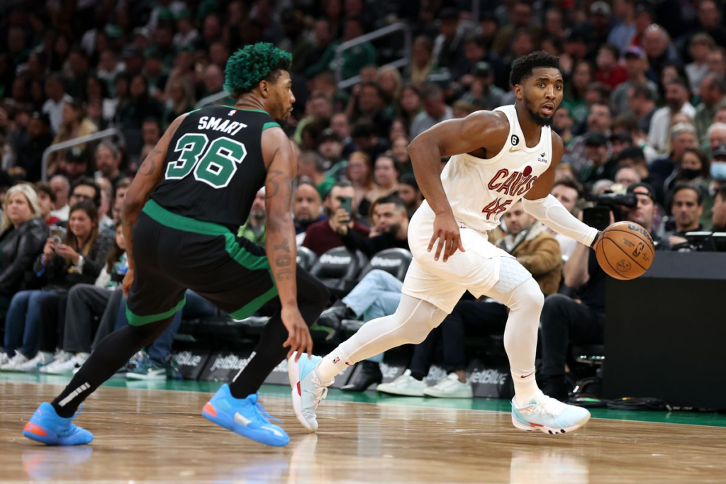 Boston Celtics guard Marcus Smart defending Cleveland Cavaliers shooting guard Donovan Mitchell.