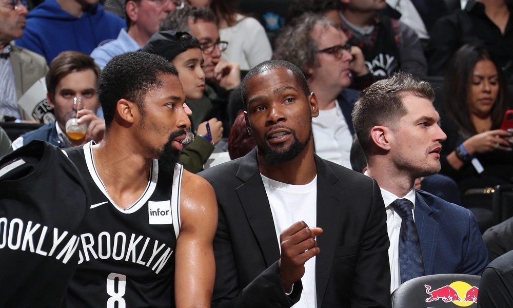 Kevin Durant and Spencer Dinwiddie talking on the bench during Dinwiddie's first stint as a Net.