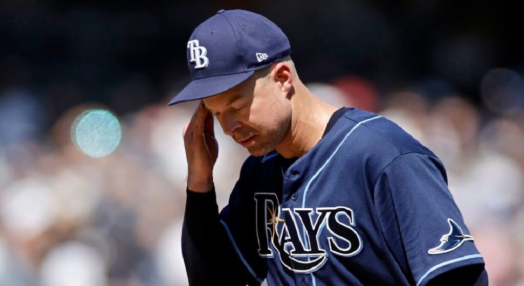 Corey Kluber, the 2023 Red Sox' Opening Day starter, pictured in a Rays uniform wiping his forehead. 