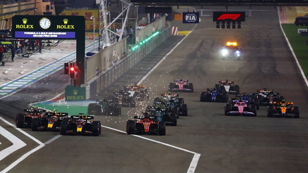 2023 F1 Bahrain GP race start: Max Verstappen leading the field into Turn One from Charles Leclerc, Sergio Perez, and Carlos Sainz (Twitter: @redbullracing)