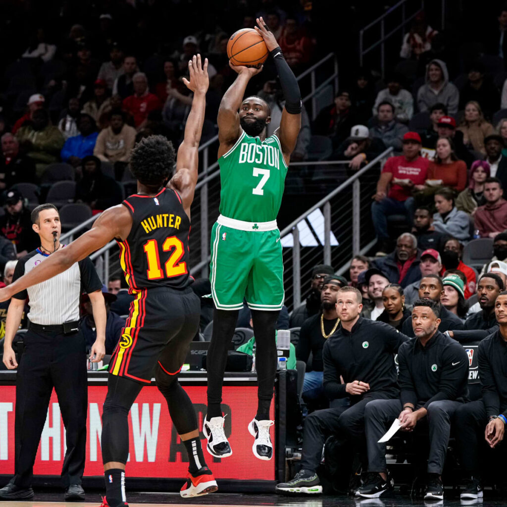 Celtics Jaylen Brown rising up to shoot over Hawks Deandre Hunter