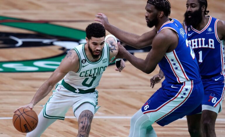 Celtics forward Jayson Tatum blowing by Sixers Center Joel Embiid