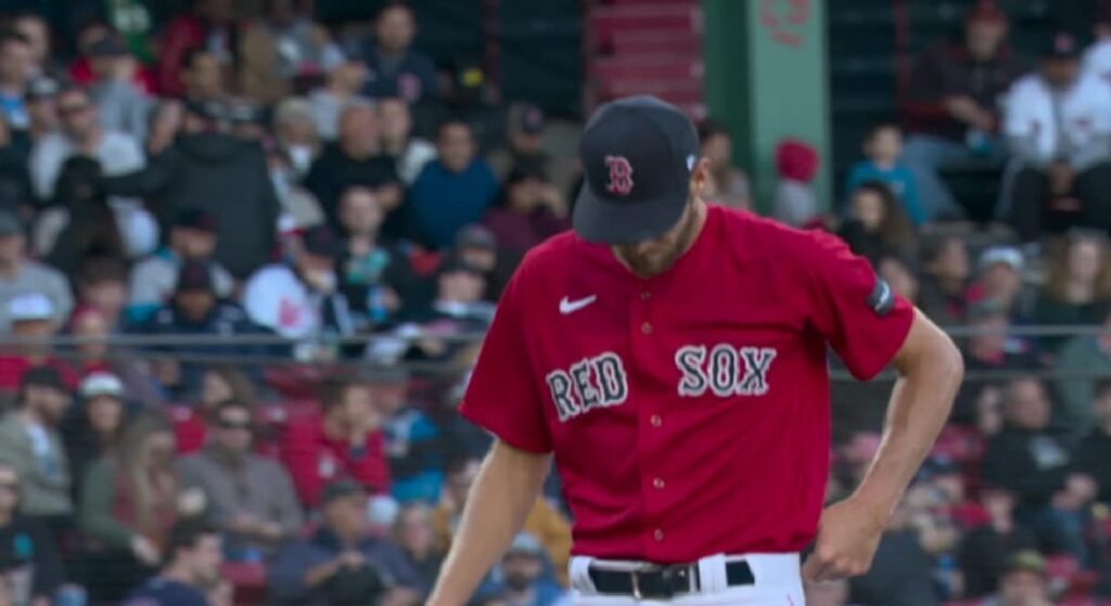Red Sox' Chris Sale lowers his head in disappointment after allowing seven runs vs. Orioles in 2023 season debut. 