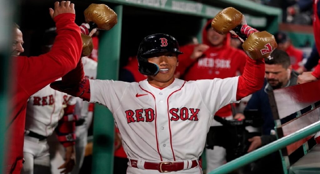 Red Sox 2023 MLB All-Star candidate Masataka Yoshida celebrates a home run, his signature fake dumbells with his number 7 on them in hand. 
