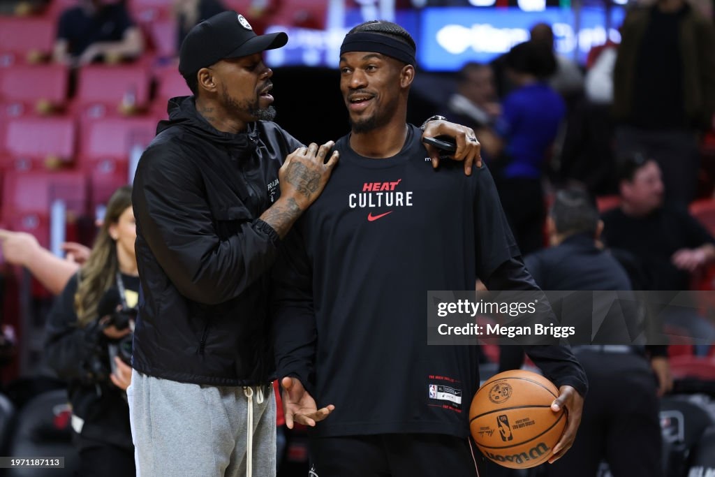 Former Miami Heat player Udonis Haslem and Jimmy Butler embrace on the court prior to a game against the Boston Celtics.